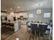 Open kitchen flows into the dining area, featuring a granite island, stainless appliances, and ample seating at 705 Hinterland Ln, Matthews, NC 28104