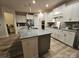 Open kitchen features a large center island with granite countertops and stainless steel appliances at 705 Hinterland Ln, Matthews, NC 28104