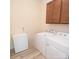 Functional laundry room with appliances, cabinet storage, and plenty of space for chores at 705 Hinterland Ln, Matthews, NC 28104