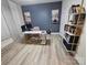 Home office features a modern desk, ergonomic chair, accent wall, and plenty of storage at 705 Hinterland Ln, Matthews, NC 28104