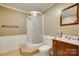 Modest bathroom showing curved shower stall, vanity, mirror and toilet in neutral color pallette at 7122 Forest Ridge Rd, Matthews, NC 28104
