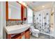 This bathroom has a single vanity, shower-tub, and updated light fixture at 7122 Forest Ridge Rd, Matthews, NC 28104