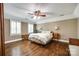 Serene bedroom with hardwood floors, shuttered windows, and a ceiling fan at 7122 Forest Ridge Rd, Matthews, NC 28104