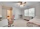 This bedroom has neutral walls, a ceiling fan, and a large window at 7122 Forest Ridge Rd, Matthews, NC 28104