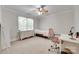 This bedroom has neutral walls, a ceiling fan, and a large window at 7122 Forest Ridge Rd, Matthews, NC 28104