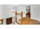 Grand foyer featuring hardwood floors, elegant lighting, and a staircase at 7122 Forest Ridge Rd, Matthews, NC 28104
