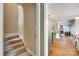 Inviting hallway featuring carpeted stairs and hardwood floors leading into a cozy living space at 7122 Forest Ridge Rd, Matthews, NC 28104