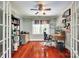 Functional home office with wood floors, built-in shelving, and ample natural light at 7122 Forest Ridge Rd, Matthews, NC 28104