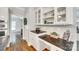 Charming kitchen featuring granite counters, white cabinets and trim, and hardwood floors at 7122 Forest Ridge Rd, Matthews, NC 28104