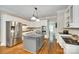 Modern kitchen featuring stainless steel appliances, island, and hardwood floors at 7122 Forest Ridge Rd, Matthews, NC 28104