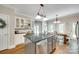 Spacious kitchen with center island, white cabinetry, and eat in area with a view at 7122 Forest Ridge Rd, Matthews, NC 28104