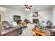Inviting living room with a brick fireplace, plush sofas, and large windows at 7122 Forest Ridge Rd, Matthews, NC 28104