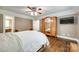 This main bedroom features hardwood floors, a ceiling fan, and an ensuite bathroom at 7122 Forest Ridge Rd, Matthews, NC 28104