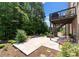 Expansive backyard patio with a firepit, lush landscaping, and a multi-tiered deck, perfect for outdoor gatherings at 733 Lingfield Ln, Waxhaw, NC 28173
