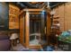 Basement view showing a personal sauna with glass door and multiple lights, next to exposed wooden wall at 733 Lingfield Ln, Waxhaw, NC 28173