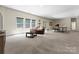 Spacious basement with carpet, large windows, and a comfortable seating area with ping pong table at 733 Lingfield Ln, Waxhaw, NC 28173