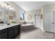 Well-lit bathroom with a soaking tub, stylish fixtures, and tiled floors offering a spa-like retreat at 733 Lingfield Ln, Waxhaw, NC 28173