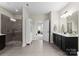 Open bathroom featuring a glass enclosed shower, stylish tile, and modern vanity with ample counter space at 733 Lingfield Ln, Waxhaw, NC 28173