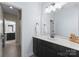 Bathroom features dark wood vanity and large mirror, offering style and functionality at 733 Lingfield Ln, Waxhaw, NC 28173