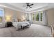 Spacious main bedroom with a tray ceiling, neutral decor, and large windows offering scenic views at 733 Lingfield Ln, Waxhaw, NC 28173