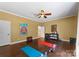 Bright bonus room with wood floors, ceiling fan, yoga mats, weights, decor, and natural light at 733 Lingfield Ln, Waxhaw, NC 28173