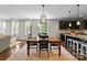 Open concept kitchen and dining room with pendant lighting and hardwood floors at 733 Lingfield Ln, Waxhaw, NC 28173