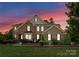 Beautiful brick two-story home with landscaped front yard and a combination of brick and stone facade at 733 Lingfield Ln, Waxhaw, NC 28173