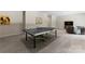 View of a game room with a ping pong table, windows, and comfortable seating area at 733 Lingfield Ln, Waxhaw, NC 28173