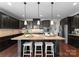 Gourmet kitchen with a large island, stainless steel appliances, and pendant lighting creating an inviting atmosphere at 733 Lingfield Ln, Waxhaw, NC 28173