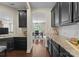 View from the kitchen area into formal dining room with dark cabinets and tiled backsplash at 733 Lingfield Ln, Waxhaw, NC 28173