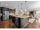 Open kitchen with a center island, stainless steel appliances, and dark wood cabinetry at 733 Lingfield Ln, Waxhaw, NC 28173