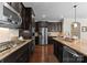 Well-equipped kitchen with stainless steel appliances, stone countertops, and dark cabinetry at 733 Lingfield Ln, Waxhaw, NC 28173