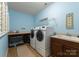 Well-lit laundry room equipped with washer, dryer, utility sink, and ample counter space at 733 Lingfield Ln, Waxhaw, NC 28173