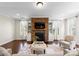 Bright living room featuring a stone fireplace and built-in shelving for ample storage at 733 Lingfield Ln, Waxhaw, NC 28173