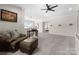 Inviting living room featuring a comfortable leather sofa and plush carpeting at 733 Lingfield Ln, Waxhaw, NC 28173