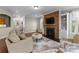 Inviting living room features a stone fireplace and decorative area rug, ideal for entertaining guests and Gathering at 733 Lingfield Ln, Waxhaw, NC 28173