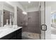 Walk-in shower with grey tile surround, glass door and built-in bench at 733 Lingfield Ln, Waxhaw, NC 28173