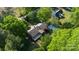 Aerial view featuring a home with a deck, a shed, and surrounded by mature trees and well-kept landscaping at 8222 Henry Harris Rd, Fort Mill, SC 29707