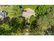 Aerial shot shows a quaint home surrounded by mature trees, offering a private and serene setting at 8222 Henry Harris Rd, Fort Mill, SC 29707