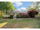 Spacious backyard with a large deck, green lawn, and colorful azaleas adding beauty to the outdoor space at 8222 Henry Harris Rd, Fort Mill, SC 29707