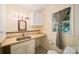 Cozy bathroom featuring a vanity with sink, neutral countertop, and window with natural light at 8222 Henry Harris Rd, Fort Mill, SC 29707