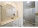 Bathroom with bright lighting, vanity, and shower/tub combo with white tiling at 8222 Henry Harris Rd, Fort Mill, SC 29707