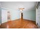 Spacious bedroom with hardwood floors, ceiling fan, and ensuite bathroom at 8222 Henry Harris Rd, Fort Mill, SC 29707