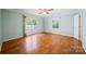 Sunlit bedroom featuring hardwood floors, French doors, and a ceiling fan at 8222 Henry Harris Rd, Fort Mill, SC 29707