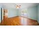 Bedroom features hardwood floors, pale blue walls, white trim, a ceiling fan, and access to the back deck at 8222 Henry Harris Rd, Fort Mill, SC 29707