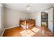 Bedroom with hardwood floors, a ceiling fan, and natural light from the window at 8222 Henry Harris Rd, Fort Mill, SC 29707