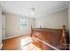 Bedroom with hardwood floors, a ceiling fan, and natural light from the window at 8222 Henry Harris Rd, Fort Mill, SC 29707