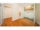 Bedroom with wood floors, closet and access to a partially finished bathroom/laundry room at 8222 Henry Harris Rd, Fort Mill, SC 29707