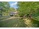 Charming brick home with mature trees and lush landscaping creates a peaceful, inviting curb appeal at 8222 Henry Harris Rd, Fort Mill, SC 29707