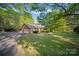 Brick home with a detached carport features a well-kept lawn and ample parking space at 8222 Henry Harris Rd, Fort Mill, SC 29707